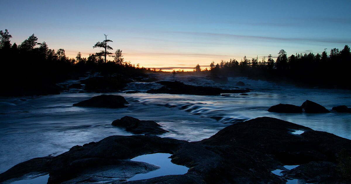 Solnedgång över Trollforsen i Piteälven